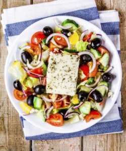 Greek salad of organic vegetables with tomatoes, cucumber, red onion, olives and feta cheese.